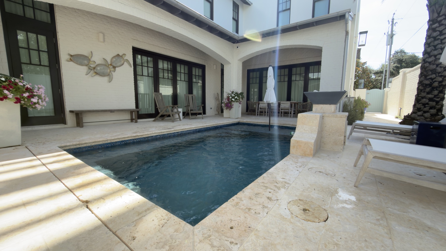 Rectangular courtyard pool and travertine deck at a Destin home maintained by WittCo Pools