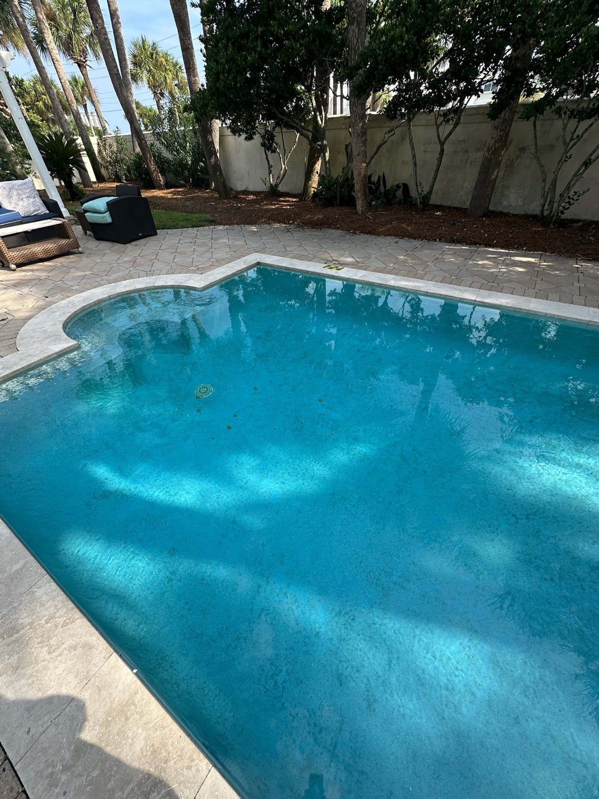 Clear travertine deck pool in Santa Rosa Beach on WittCo Pools weekly service